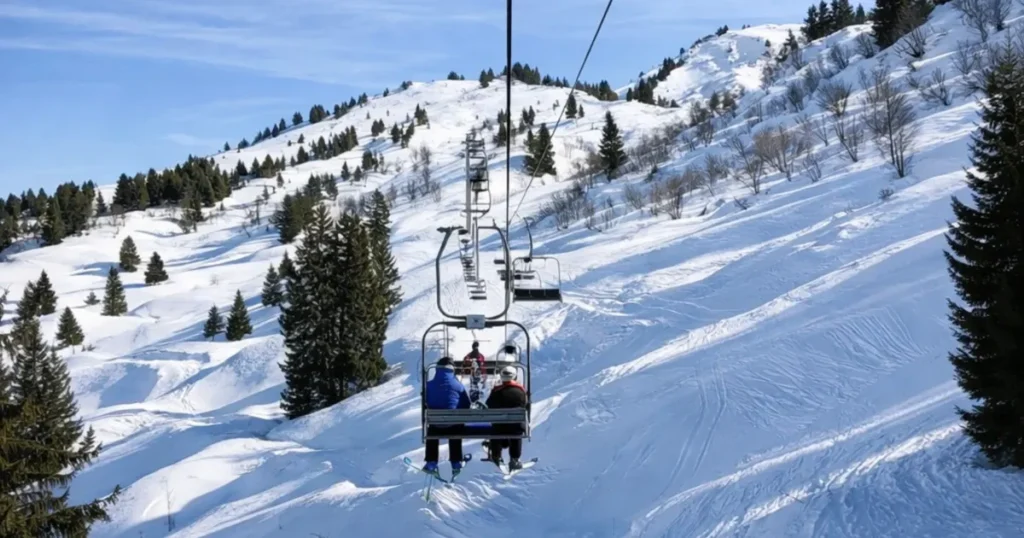 Skiers riding a chairlift up a steep snow-covered mountain in the Alps, offering the best december vacations for winter sports.