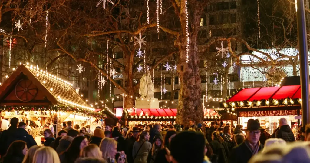 Illuminated wooden stalls at a German Christmas market, highlighting the best places to visit in december