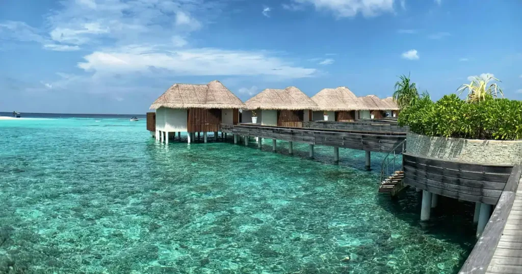 Overwater bungalow in the Maldives, a luxurious hot place to visit in December.