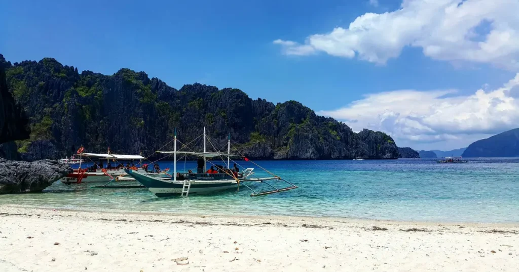 Clear waters of Palawan, one of the best places to travel in December for warm weather.