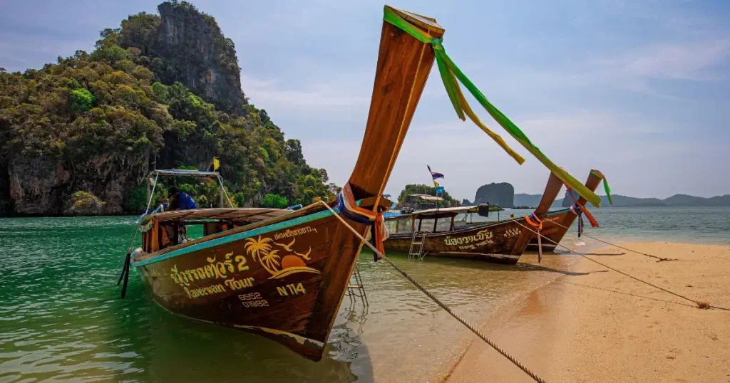 Traditional longtail boats on a sunny beach in Thailand, one of the best countries to visit in december