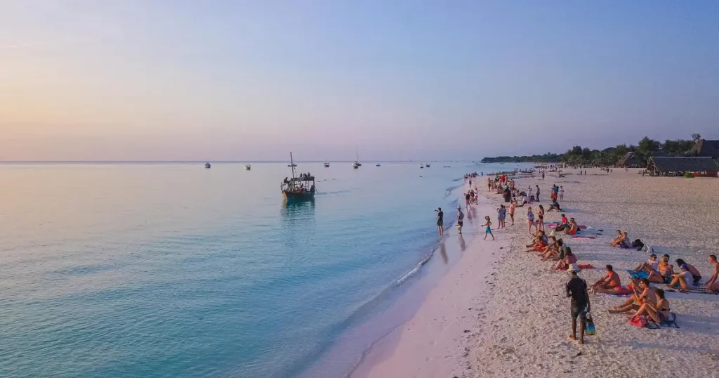 Traditional dhow on Zanzibar beach, highlighting hot locations in December.