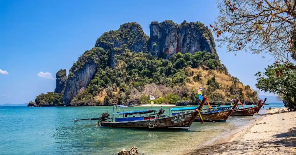 Longtail boat on a Phuket beach, ideal for places to go in december hot.